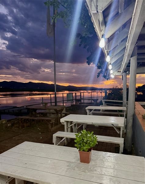 Sunset patio dining with string lights — discover Harties venues in the Food tab